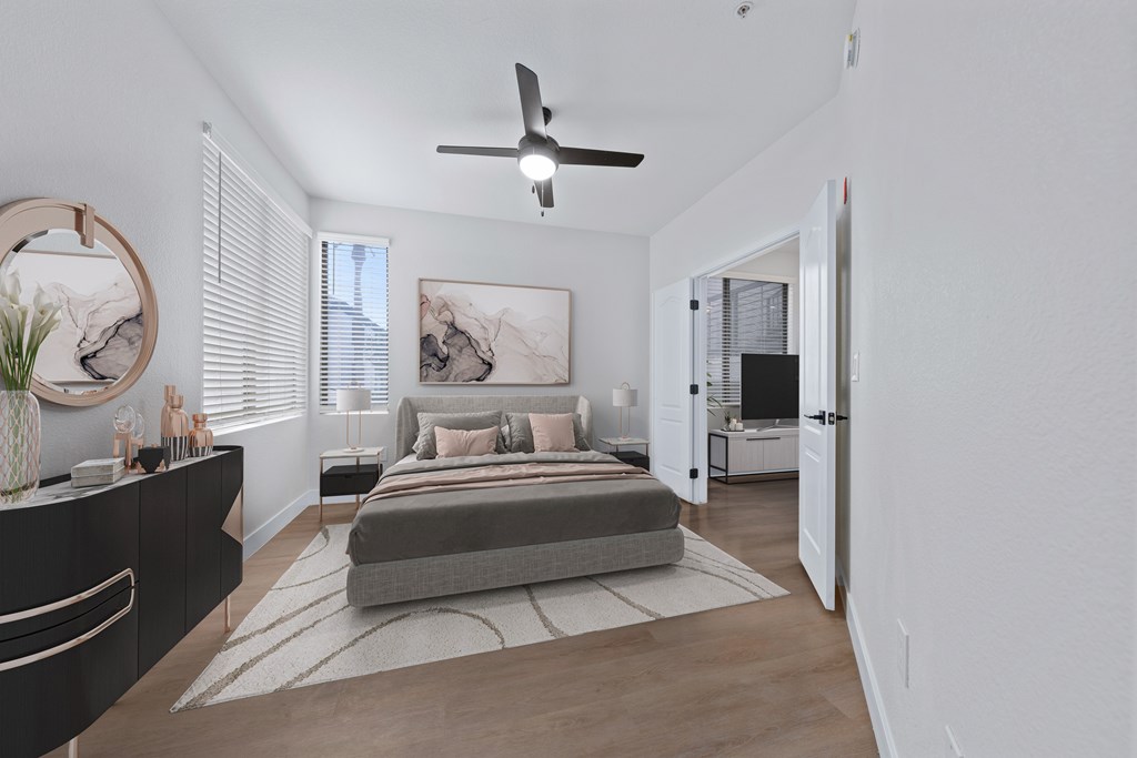 a bedroom with a bed and a ceiling fan